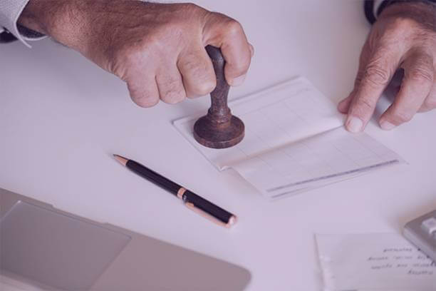 Official document being stamped during professional document preparation